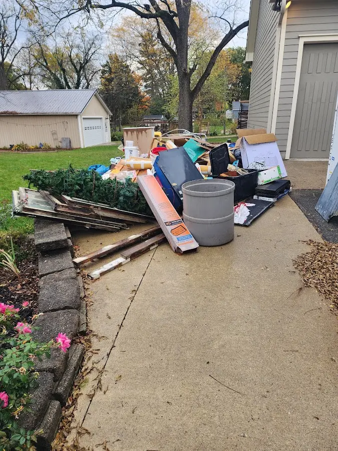 Dumpster being loaded with debris for Estate Cleanout Dumpster Rental in Eastwood